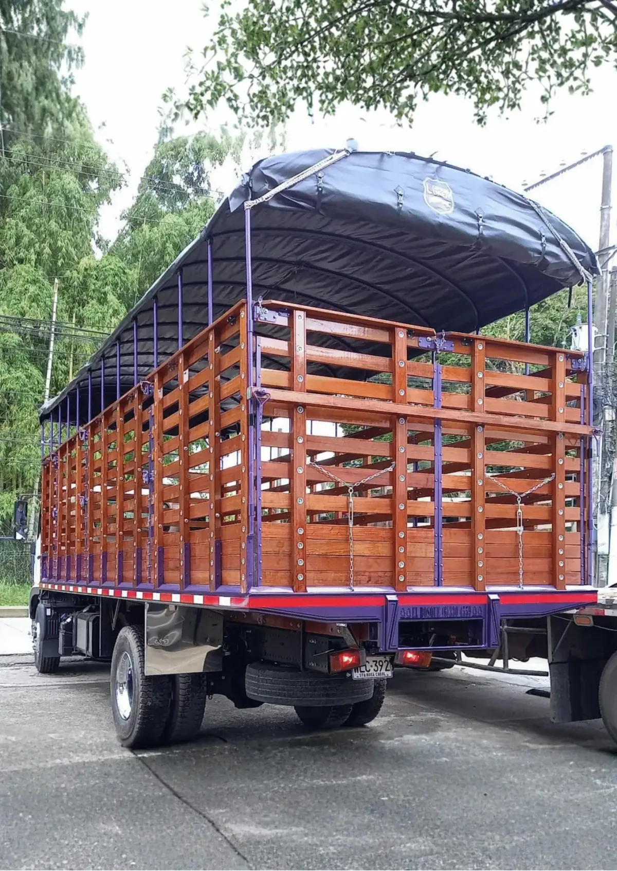 Camión con carrocería en madera y carpa azul después del mantenimiento